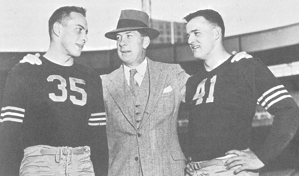 Army’s 1945 backfield stars Felix “Doc” Blanchard (35) and Glen Davis (41) flank head coach Red Blaik.